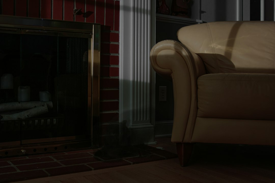 A cozy living room with a fireplace and sofa